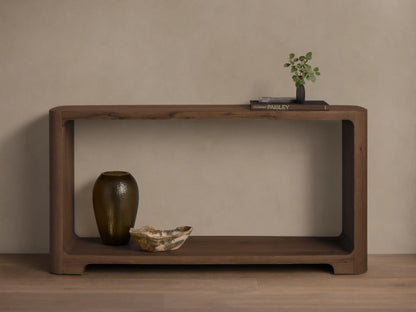 Front view of the dark brown Redding Console Table with a lower shelf and rounded edges, styled with vases and books.