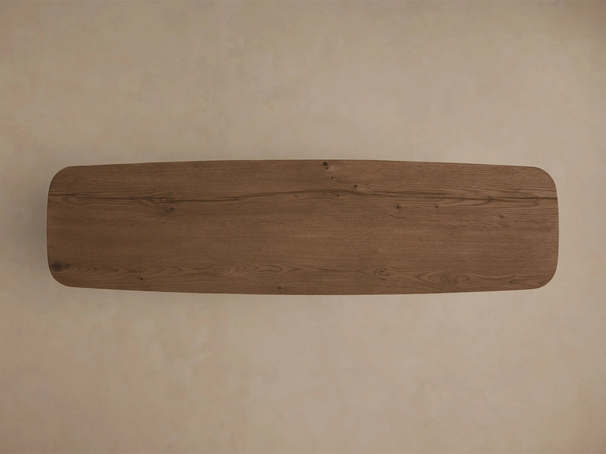 Front view of the Redding Console Table, a rectangular oak wood table with rounded corners and a lower shelf, in a medium brown finish.