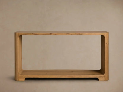 Front view of the natural wood Redding Console Table, featuring a curved design, upper surface, and lower shelf with decorative items.