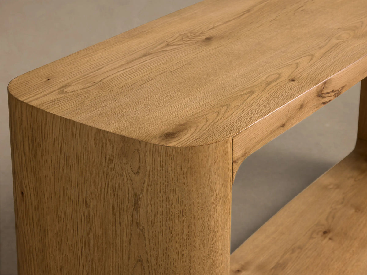 Front view of the Redding Console Table, made of light natural oak wood, with rounded corners and a lower shelf.