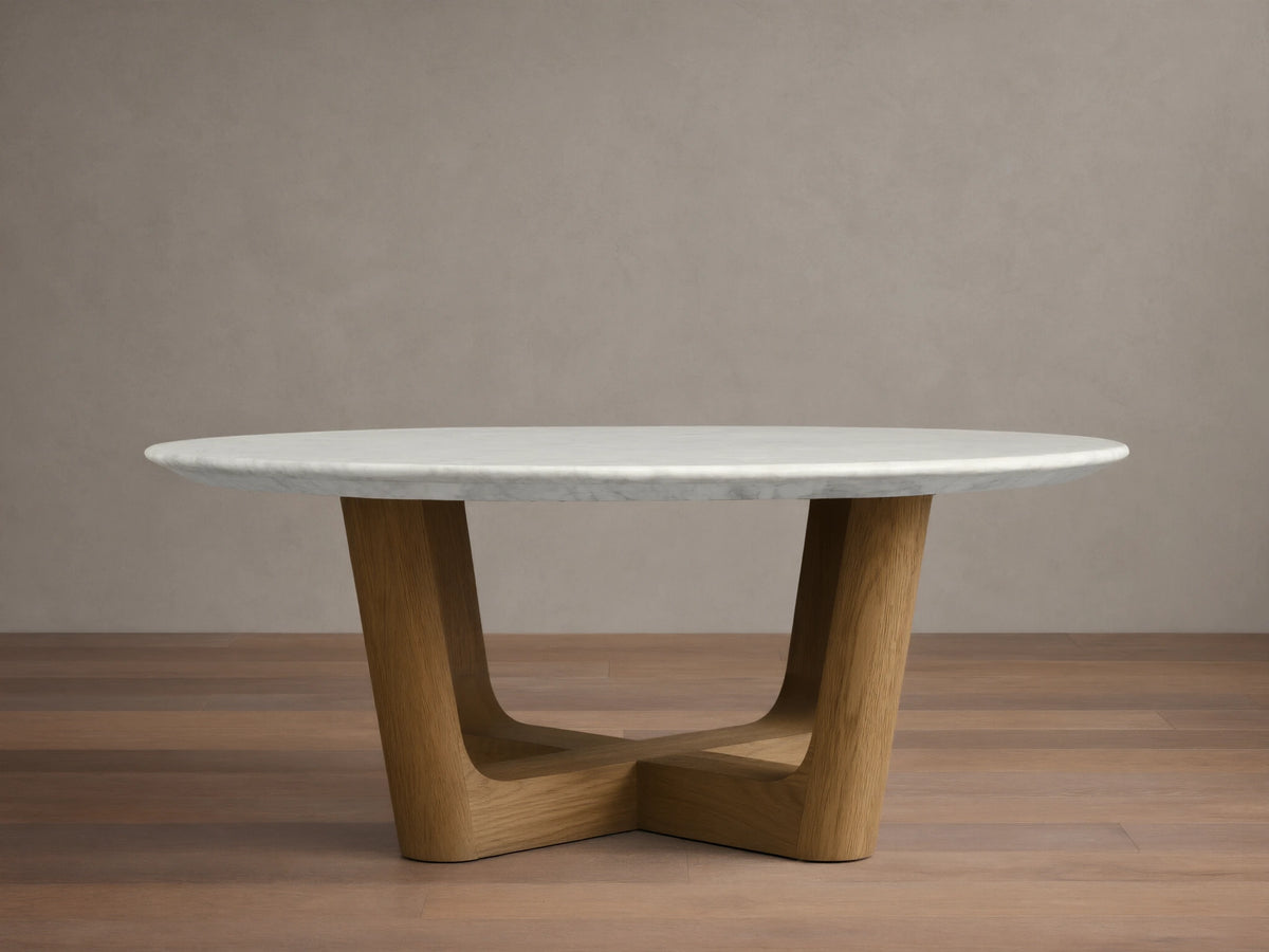 Front view of the Saint Germain Round Stone Coffee Table with a white marble top and a natural oak Rennes base.