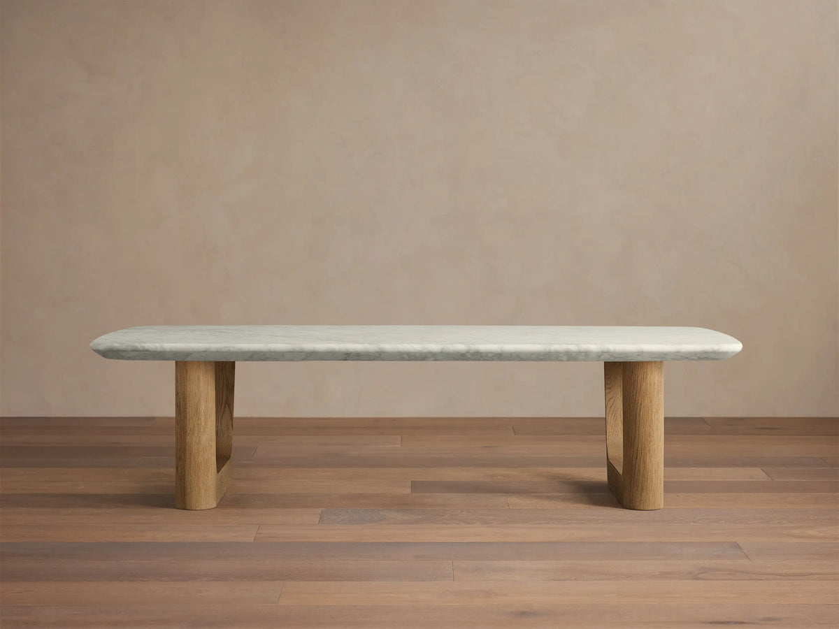 Front view of the Saint Germain Stone Coffee Table with Rennes Base, a light gray marble top with rounded edges and light brown oak legs.