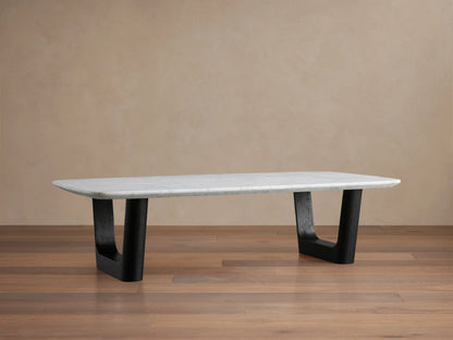 Saint Germain Stone Coffee Table with Carrara marble top, featuring a rectangular shape and black base, on wooden floor.