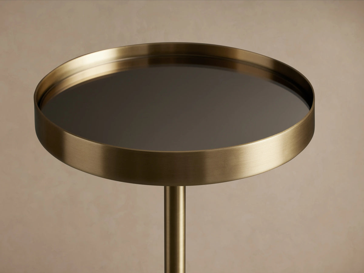 Rhodes Martini Table with antiqued brass finish, round mirrored tabletop tray in black reflecting light, on a single iron pedestal.