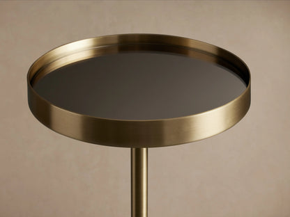 Rhodes Martini Table with antiqued brass finish, round mirrored tabletop tray in black reflecting light, on a single iron pedestal.