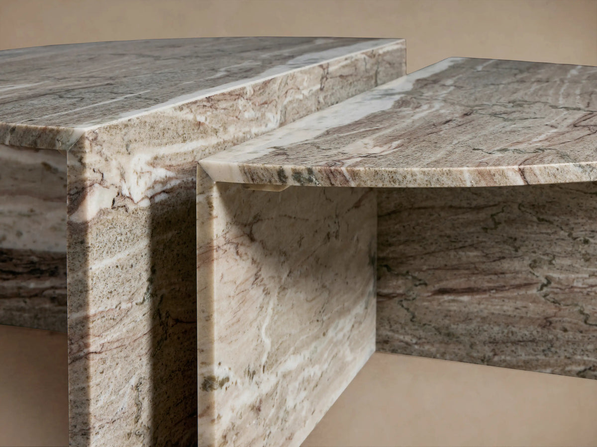 Close-up of the Riggs Coffee Table featuring a layered design in textured stone with earthy tones, showing its geometric form.