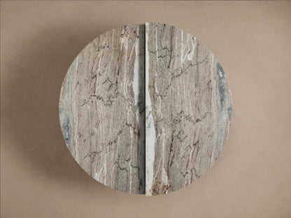 Riggs Coffee Table with a round, split design featuring a natural stone pattern in shades of brown and beige on a neutral background.