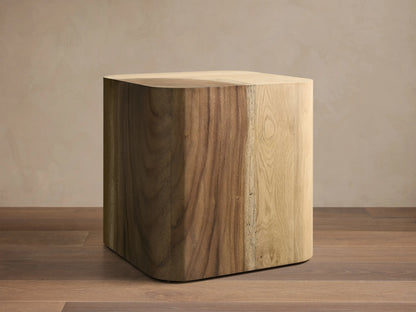Front view of the Ramiro End Table, a cube-shaped table of natural American oak and Guanacaste wood with rounded edges and varied grains.