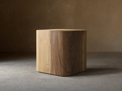 Front view of the Ramiro End Table, a cube-shaped table of natural American oak and Guanacaste wood with rounded edges and varied grains.
