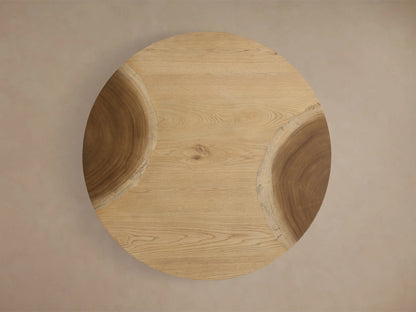 Close-up of a light brown, curved solid wood table, featuring natural wood grain patterns and a smooth finish.