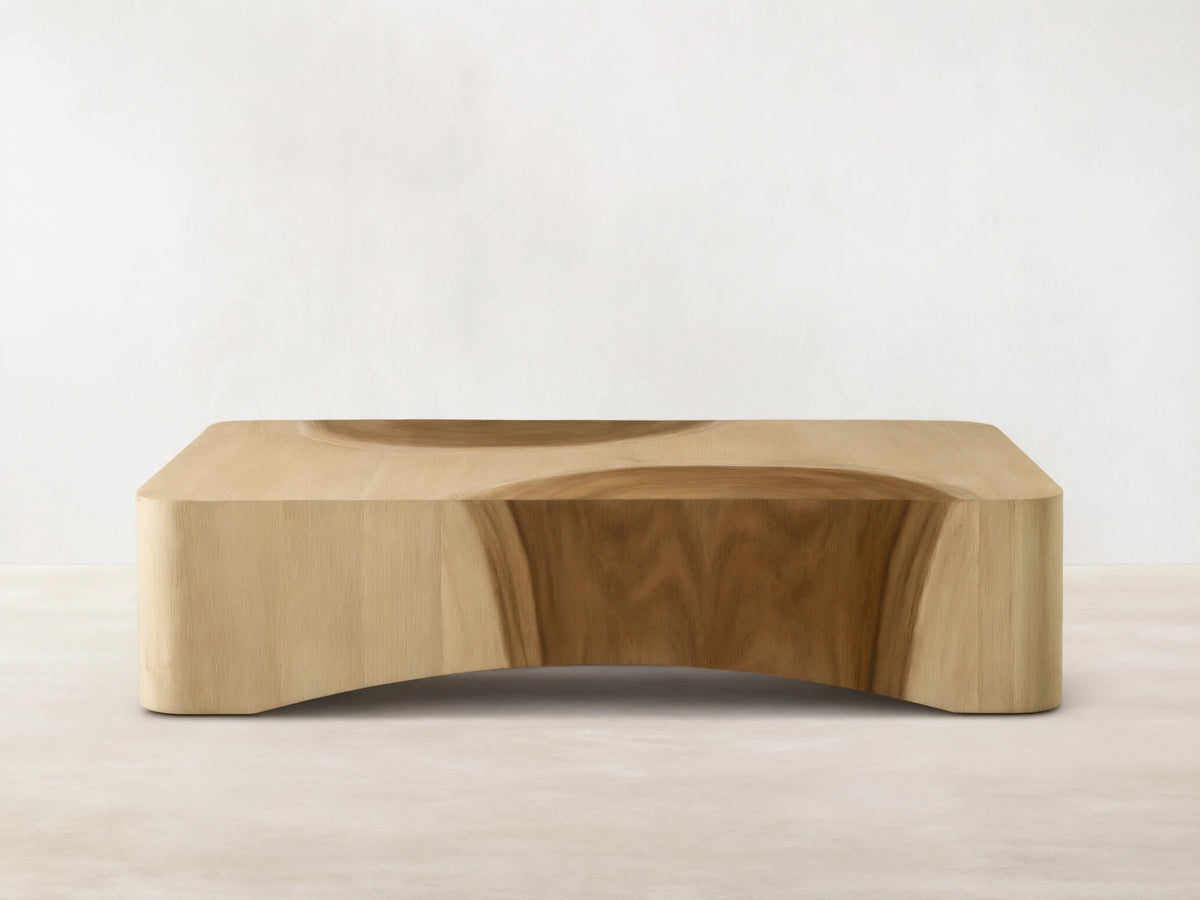 Ramiro Coffee Table: light oak wood, low rectangular shape, dark curved Guanacaste wood inlays, and curved base.