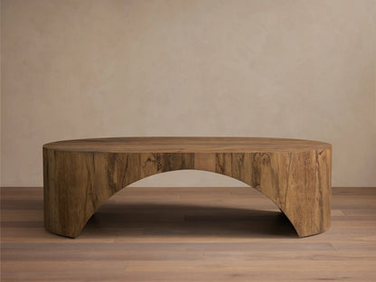 Front view of the aged brown San Rafael Coffee Table. This oval coffee table features a thick top and gracefully curved, arched legs.