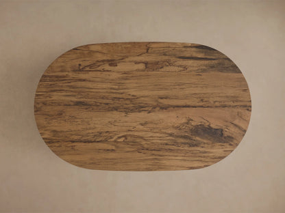 Front view of the oval San Rafael Coffee Table, featuring an aged brown wood finish and a distinctive arched base.
