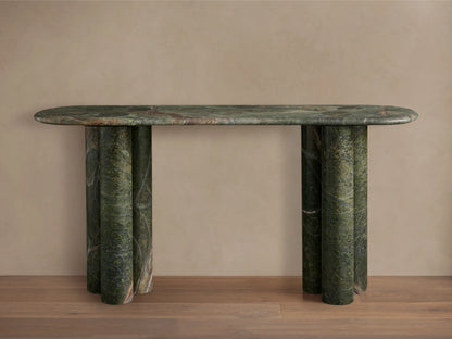 Serafin Console Table, oval green marble top, three rounded column legs on each side, against a neutral wall & wood floor.