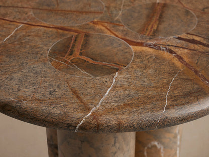 Serafin End Table made of natural stone with round top and two column legs, displaying unique veining and color variations.