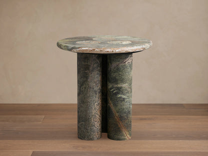 Serafin End Table with a round stone top and two column-style legs, showcasing natural veining and color variations.