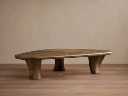 Soumaya Coffee Table: Organic, triangular spalted primavera wood coffee table with radial grain top, thick mahogany legs on wood floor.