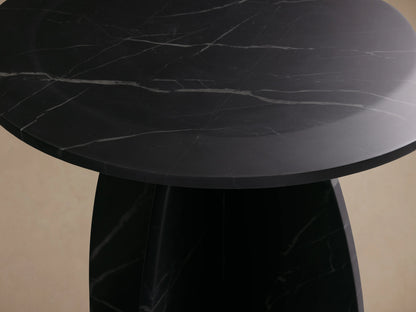 Solstice End Table with round black marble top and matching laminate legs, displaying white veining patterns against a neutral background.