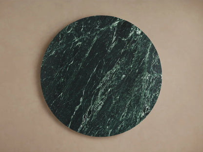 Solstice End Table in green marble; round top with unique three-piece intersecting base, crafted in artisan style.