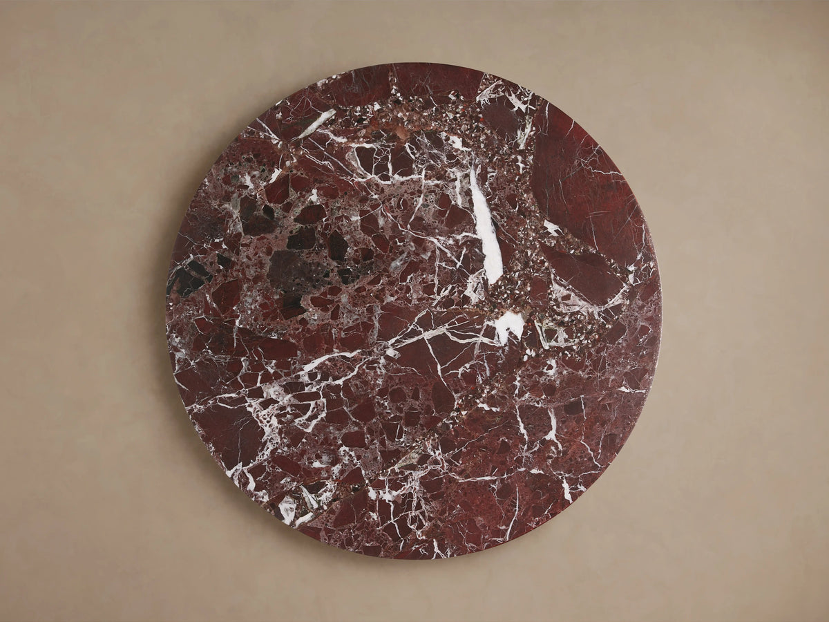 Round Solstice End Table top made of rich red marble with white veining, showcasing a polished, natural stone texture.