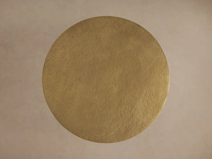 Top-down view of the circular gold aluminum tabletop of the Soma Martini Table with a textured, hand-applied patina finish.