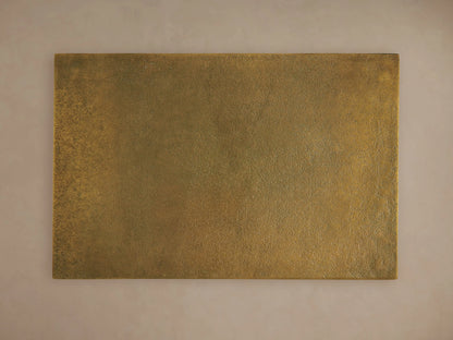 Front view of the Soma C Table, featuring a rectangular gold patinaed tabletop and a black C-shaped frame.