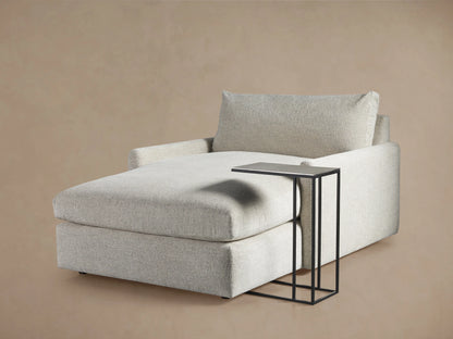 Soma C Table with a textured dark aluminum tabletop and sleek metal edges, supported by slim iron legs.