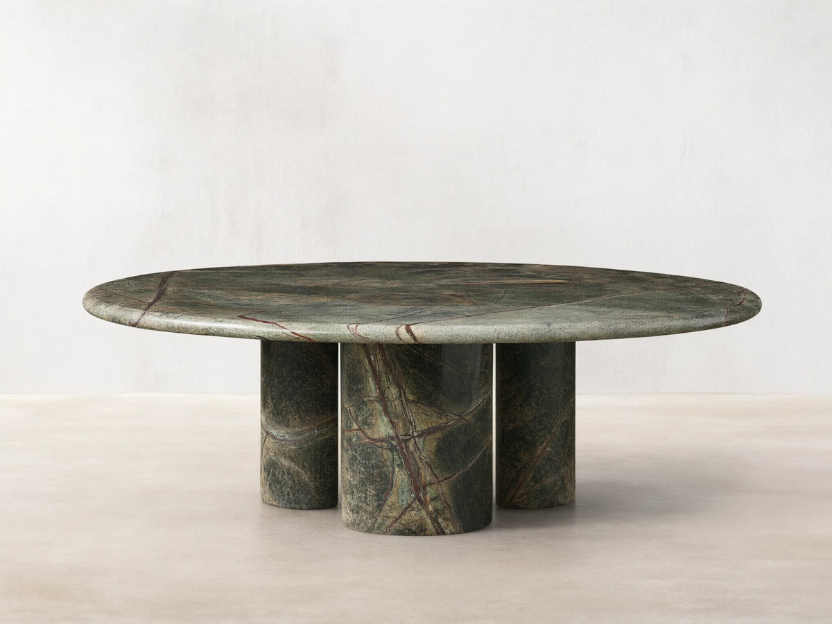 Front view of the green marble Serafin Coffee Table with a round top and three cylindrical legs, featuring natural veining.