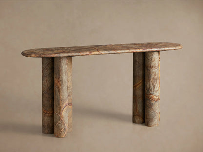 Close-up of polished brown, grey, reddish-brown veined marble table with curved edge, two circular cutouts, and thick legs.