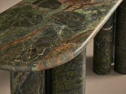 Front view of green variegated marble console table with an oval top and four clustered cylindrical legs.