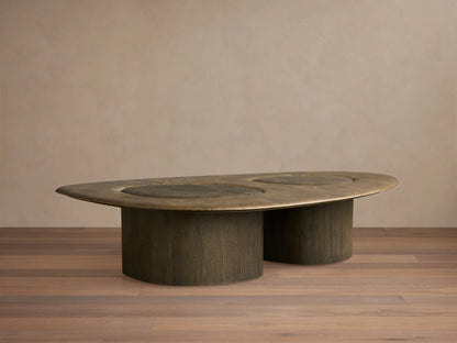 Organic-shaped Sucurro Coffee Table with an oxidized aluminum top showing patina and dark spalted primavera wood drum bases.