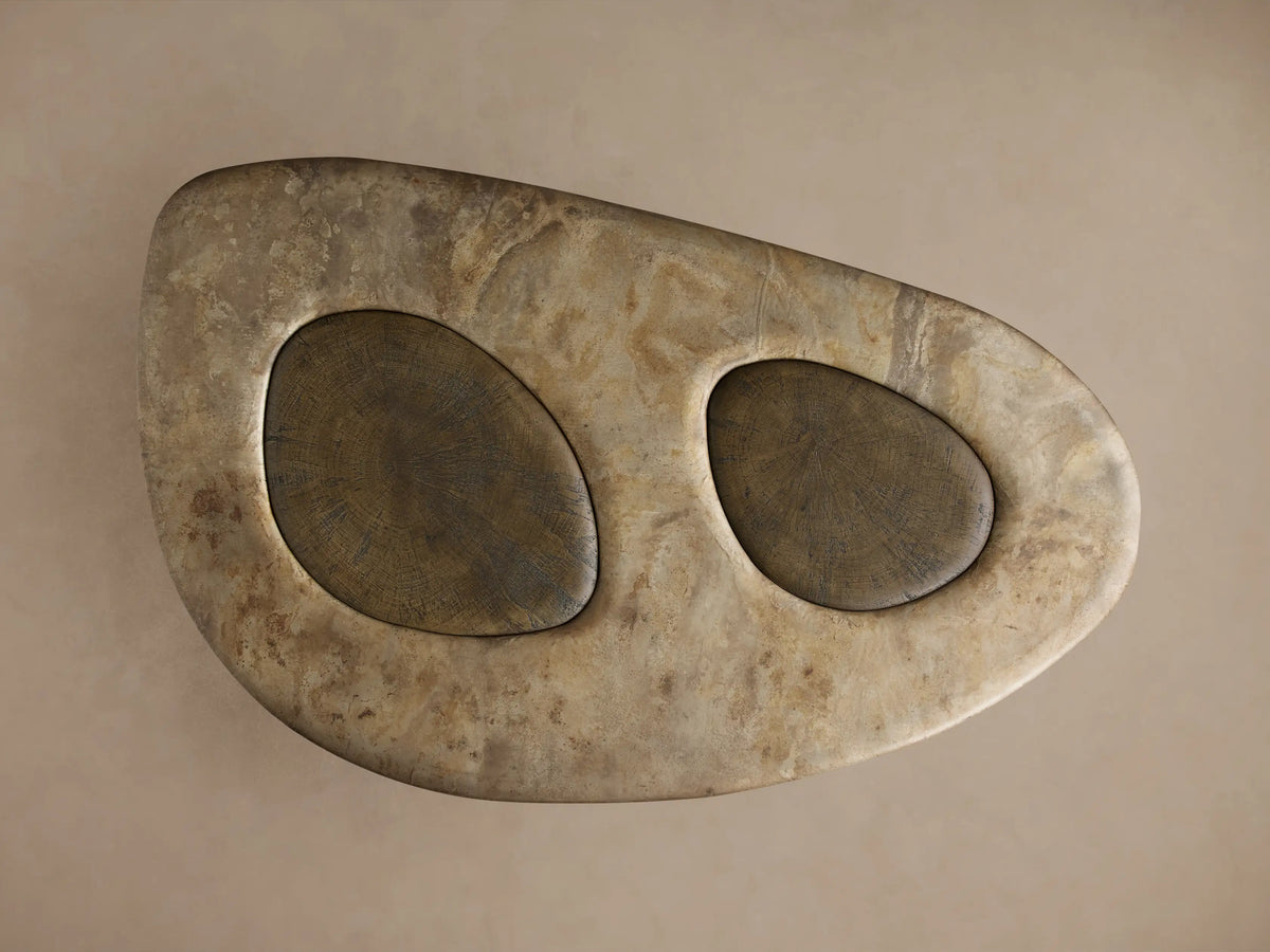 Close-up of Sucurro Coffee Table's light brown oxidized aluminum top with two dark brown spalted primavera wood inlays.