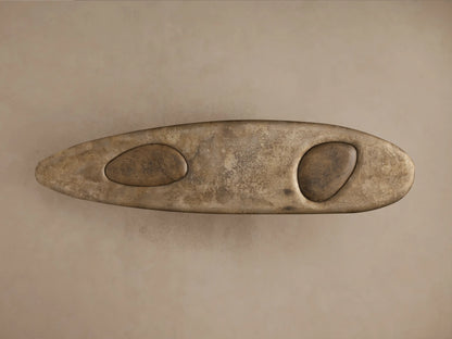 Close-up of Sucurro Console Table: oxidized aluminum top with organic shape & oval cutout, dark textured spalted primavera wood base.