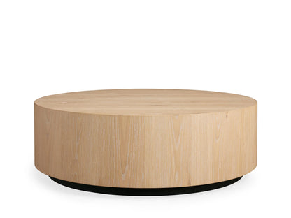 Sullivan Round Coffee Table made of light European oak, featuring natural cracks and knots, viewed from above on a beige background.