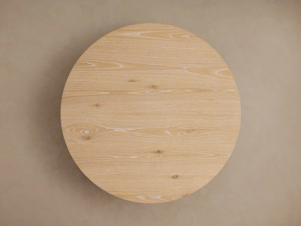 Sullivan Round Coffee Table made of light oak wood with visible grain patterns, showing a circular tabletop and smooth edges.