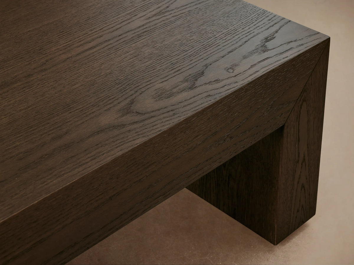 Sullivan Waterfall Coffee Table made of dark European oak with visible grain patterns, featuring a seamless waterfall design from top to sides.