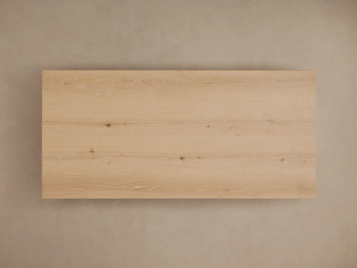 Sullivan Waterfall Coffee Table with natural oak grain, miter joinery showing a seamless top to side flow, and organic wood features.