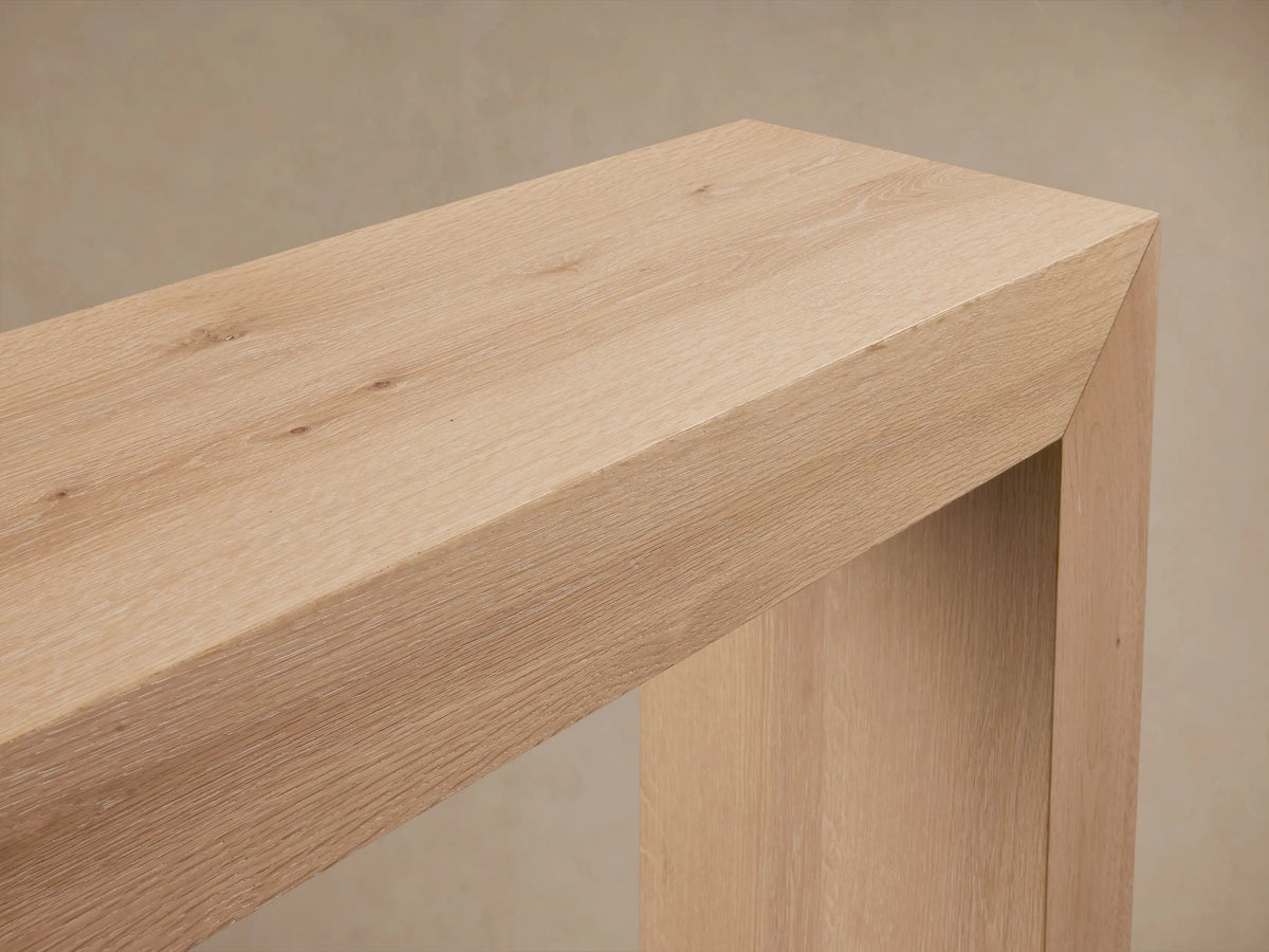 Sullivan Console Table made of solid oak, showcasing a waterfall edge design with visible natural wood grain and knots.