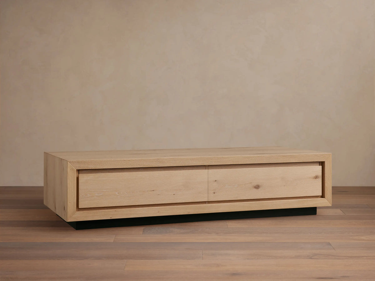 Front view of the dark brown Sullivan Storage Coffee Table, made of solid oak with two soft-close drawers and a plinth base.