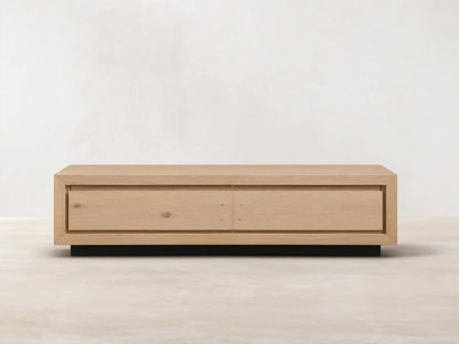 Sullivan Storage Coffee Table made of natural European oak with visible cracks and knots, on a black plinth base, front view.