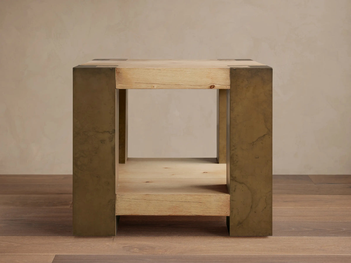 Telluride End Table with light oak wood top and shelf, flanked by distressed dark brass-colored oxidized steel sides.