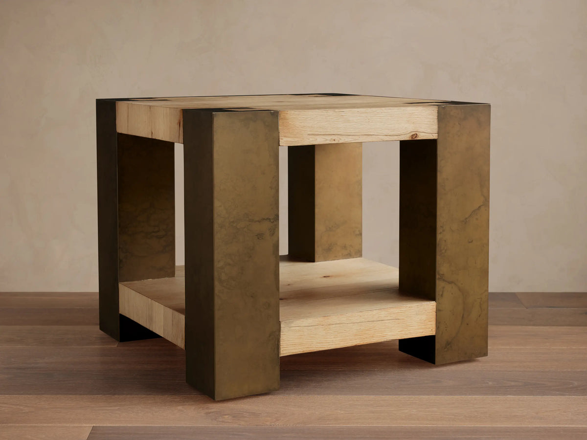 Telluride End Table with light oak wood top and shelf, flanked by distressed dark brass-colored oxidized steel sides.