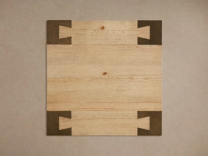 Close-up of Telluride End Table's light oak wood top with visible grain and dark oxidized steel leg with geometric cutouts.