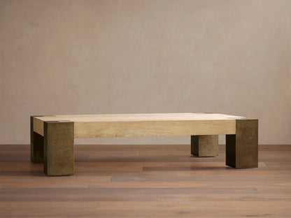 Telluride Coffee Table, light oak veneer top with visible grain, naturally oxidized steel legs & corner accents, on a wood floor.
