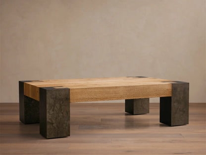 Front view of Telluride Coffee Table with light oak wood plank top on four dark, mottled oxidized steel block legs.