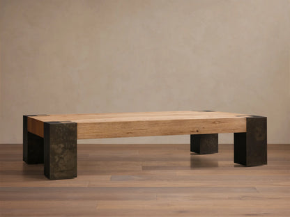 Front view of the Telluride Coffee Table, featuring a light oak veneer top and dark oxidized steel legs with mottled patinas.
