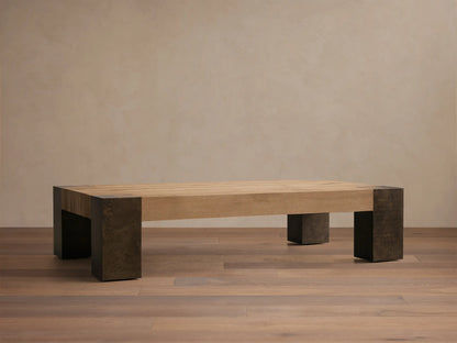 Front view of Telluride Coffee Table with a light natural oak wood plank top and dark, weathered steel legs and corner accents.