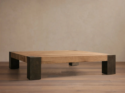 Top-down view of a light brown wood Telluride Square Coffee Table with dark oxidized steel corner accents.