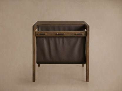 Top view of the Thorin Magazine Table, showing a solid oak wood surface with a brown leather sling held by wooden dowels.
