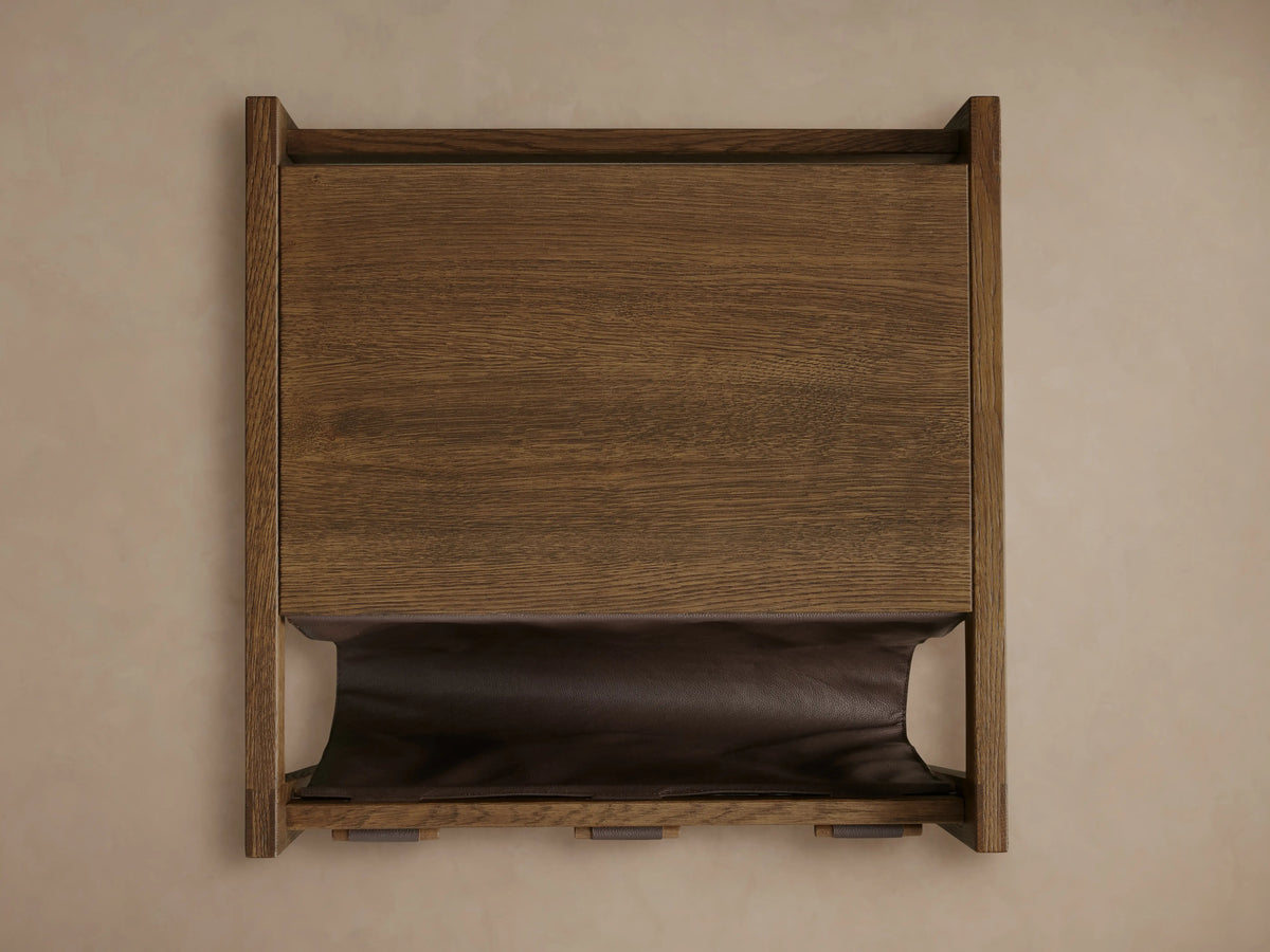 Thorin Magazine Table with solid oak frame and dark brown leather sling, front view. Wood dowels secure the sling.